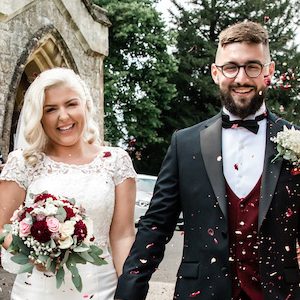 A couple are showered with confetti on their wedding day.
