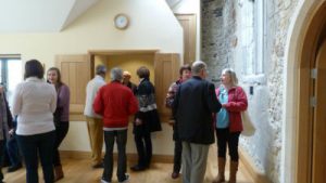 A photo of people in Addington Church Room having a cup of tea after church.